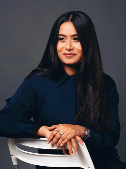 A relaxed and approachable corporate portrait. The slight smile and casual pose make the subject seem friendly and open.