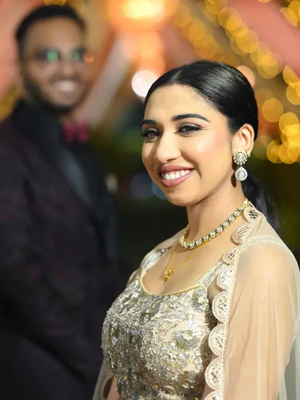 A beautiful portrait of the reception bride. Her smile shines, and her makeup looks radiant and sophisticated, perfect for her evening celebration.