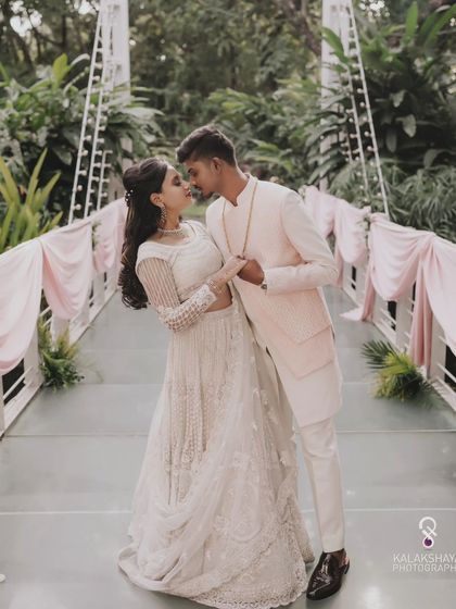 A romantic moment from an engagement shoot, with the couple sharing a quiet embrace on a bridge.