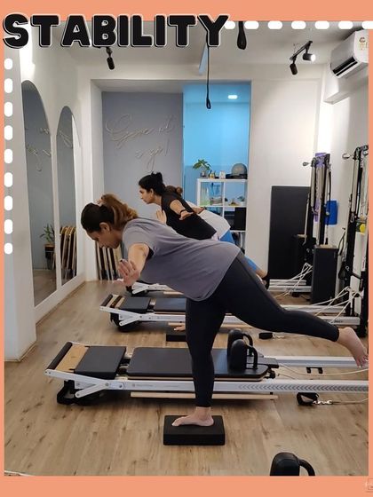 Stability is a key focus in our classes. Here, our members demonstrate balance and control during a single-leg exercise.