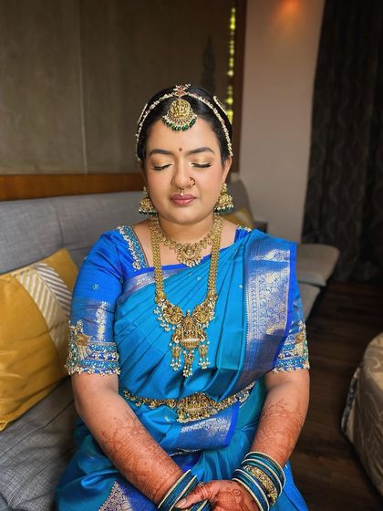 A serene, eyes-closed portrait of the Iyengar bride, showcasing the soft, blended eyeshadow and flawless skin.
