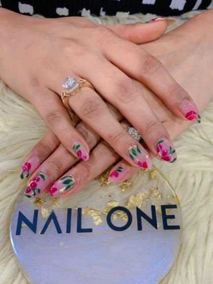 A closer look at the floral nail art, showcasing the vibrant colors and the delicate brushwork that brings the flowers to life.