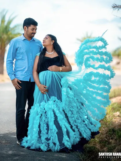 We love creating dynamic and joyful portraits. Here, we used a flowing maternity gown to add a sense of movement and elegance against a simple outdoor path, highlighting the couple's happy anticipation.