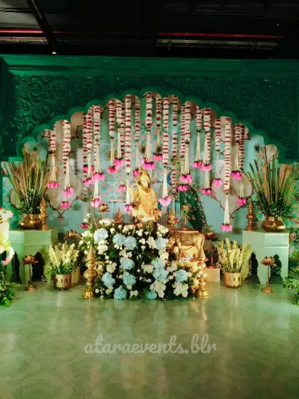 An evening of pure devotion and bliss. This Krishna-themed event decor was designed to create a spiritual and serene atmosphere, featuring a stunning floral arrangement, traditional brass elements, and a beautifully adorned statue of Lord Krishna.