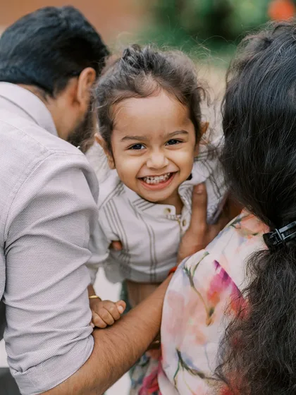 A big, toothy grin from a two-year-old girl. It's a joy to capture their growing personalities year after year.