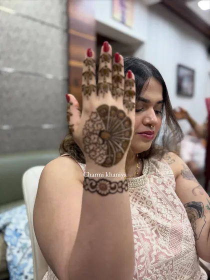 A side view of this elegant peacock mehendi. The simple floral wristband complements the main design perfectly, showing how the art wraps around the hand.