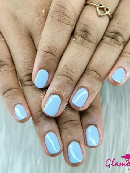 The perfect everyday color. A simple, clean, and beautifully applied coat of sky-blue gel polish on short, neatly shaped nails.