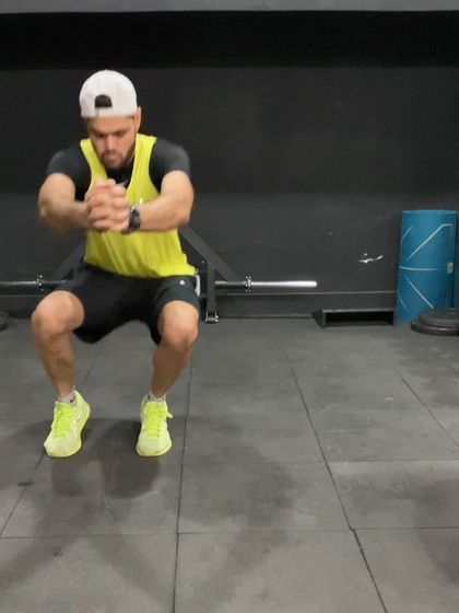 A squat jump in progress. This fundamental plyometric exercise is excellent for developing lower body power and is a staple in our programs for improving vertical leap and sprinting speed.