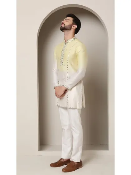 This zesty lemon and ivory ombre kurta demonstrates my playful yet elegant approach to festive wear. The design features delicate mirror work and a unique asymmetrical cut, making it an ideal choice for sangeet ceremonies or daytime celebrations.