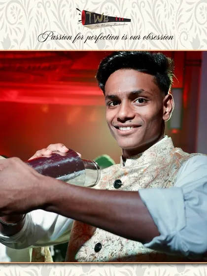 A bartender shakes a cocktail with precision, ensuring it's perfectly chilled and mixed before serving.