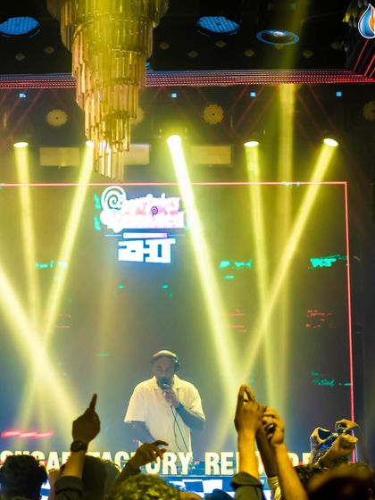 On the mic, hyping up the crowd at Sugar Factory. Engaging with the audience is a huge part of my performance.