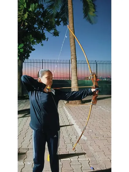 A young archer from our 2023 summer camp, showing great form against the sunset.