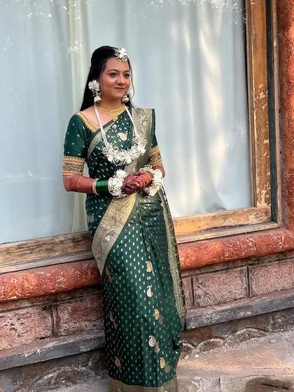 A profile shot of the bride, showing her elegant hairstyle and floral accessories.