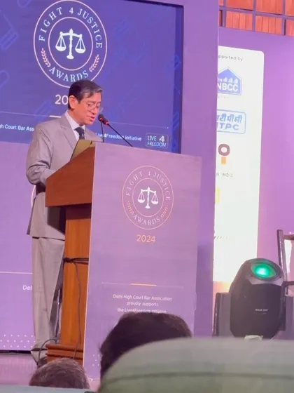 A speaker addressing the audience at the "Fight for Justice" awards, an inspiring evening for the legal community.