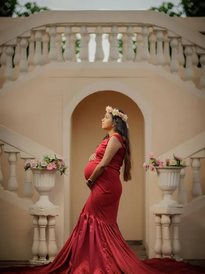 A regal and contemplative pose on a grand staircase, creating a timeless and elegant solo portrait.