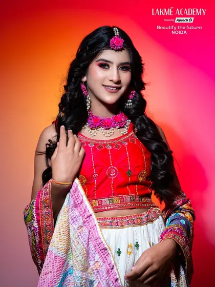 A fun and festive Haldi or Mehendi look. The colorful outfit and floral jewelry are paired with bright, playful makeup, perfect for celebrating pre-wedding functions.