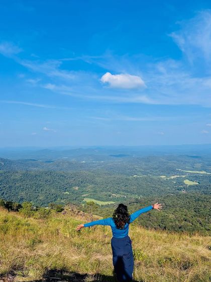A feeling of freedom, with arms outstretched, overlooking the valley.