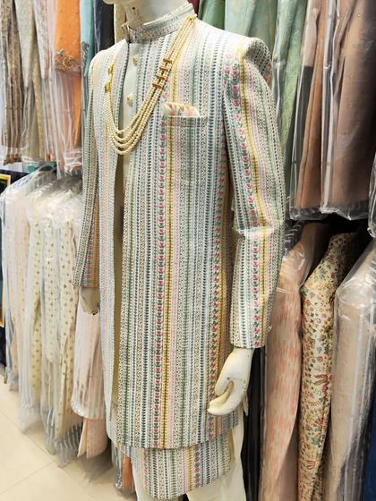 A full view of our multi-color striped open sherwani, displayed in the studio. This piece shows the variety of unique, ready-to-wear options available for grooms.