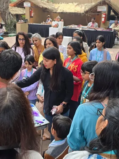 An instructor demonstrates a painting technique to a curious group of students, fostering a collaborative and interactive learning experience.