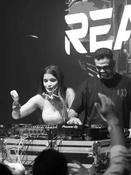 Another black and white shot with a fan, capturing a moment of interaction and shared joy.