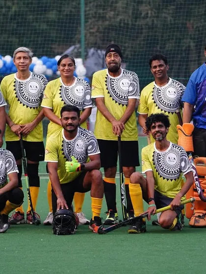 Our team in yellow jerseys posing for a photo at the hockey carnival. The event was a fantastic experience for our players.