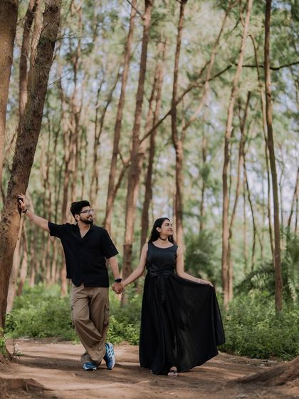 A romantic walk through a wooded path. The natural frame of the trees and the soft light make this a beautiful and timeless couple portrait.