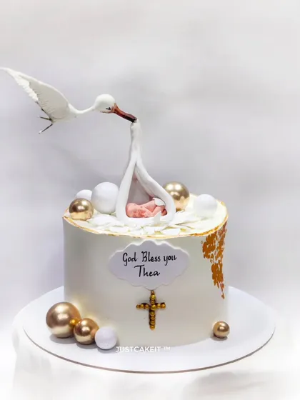 This gravity-defying Baptism cake features a hand-molded stork delivering a baby. It's a delicate and elegant design that showcases my ability to create structurally complex and meaningful edible art.