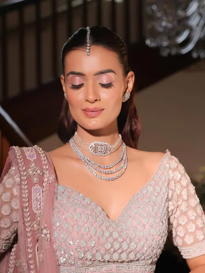 With eyes closed, you can see the soft blend of pink eyeshadow. This detail adds a touch of color and romance without being overwhelming, perfect for a minimalist bride.