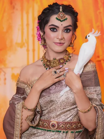 A close-up of the model, showing the beautiful details of the maang tikka and the necklace.