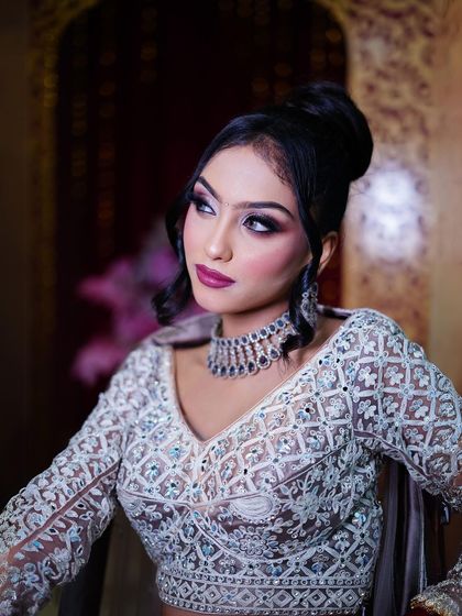 A close-up on the makeup and the elegant high bun hairstyle.