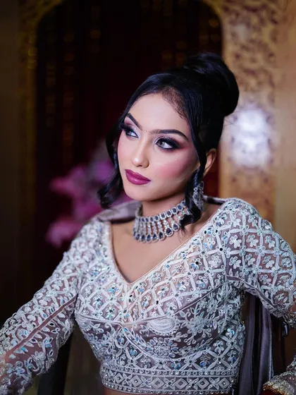 A close-up on the makeup and the elegant high bun hairstyle.