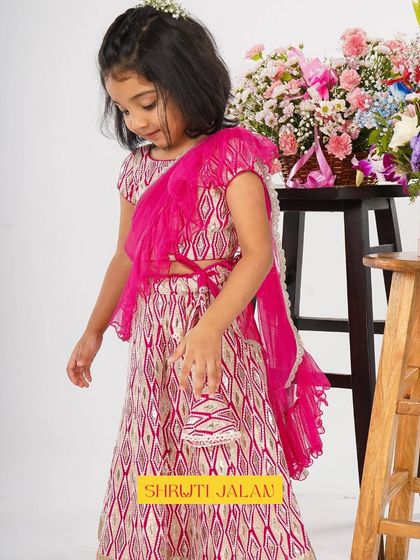 A beautiful shot of a little girl in my fuchsia pink lehenga, complete with a matching potli bag. I love adding these small accessories to complete the look and make her feel extra special.