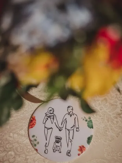 A beautifully blurred shot focusing on the custom-designed coaster that includes the couple's pet, a heartfelt nod to their furry family member.