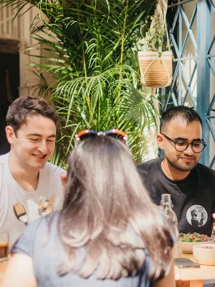 This is the energy we love. Friends gathering in our sunlit garden, sharing food, and making memories. We built this space for real connection and those slow, happy moments.