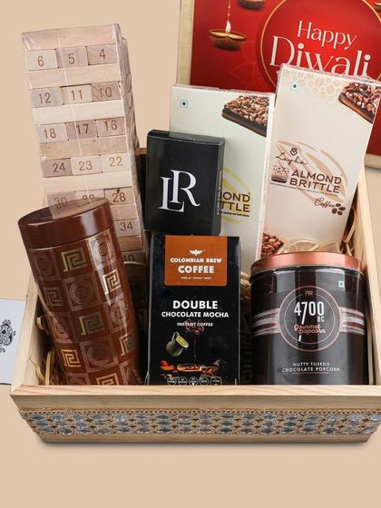 Our "Festive Fun" hamper is designed for sharing. It includes a Jenga set, playing cards, gourmet popcorn, coffee, and other treats for a perfect Diwali get-together.