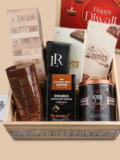 Gifting can be fun too. This 'Festive Fun' hamper includes a tumbling tower game, playing cards, coffee, and popcorn, perfect for a get-together with family and friends during the holidays.