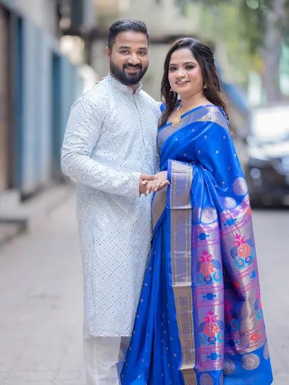 The couple walking hand-in-hand. This shot shows the complete look, with the bride's traditional saree and my signature natural makeup.