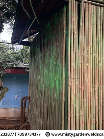 The exterior of the bamboo house, showing how the natural material blends seamlessly with the surrounding trees and landscape.