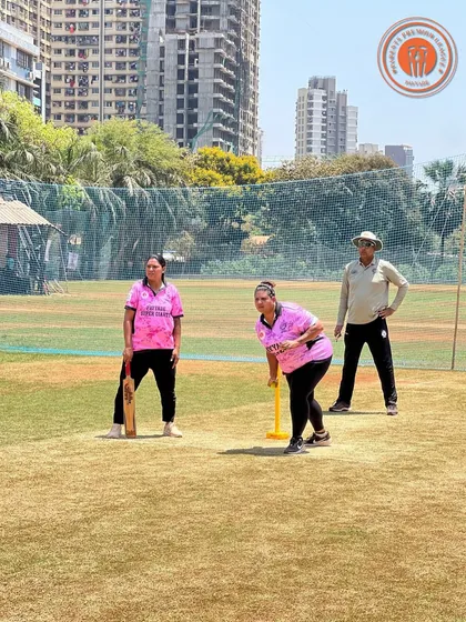 A woman in a pink jersey is captured mid-action as she bowls in a PPL match.