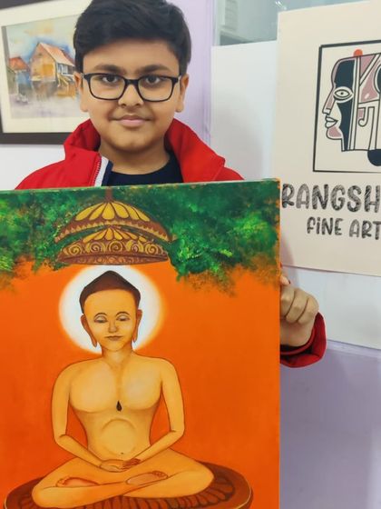 A young boy proudly presents his completed painting of a Jain Tirthankara, a project that combines artistic skill with spiritual learning.