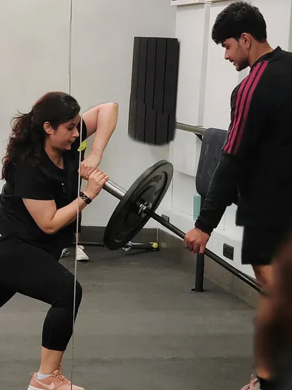 A member performs a landmine rotational exercise, a fantastic move for building core stability. Our coaches are always on hand to guide and assist.
