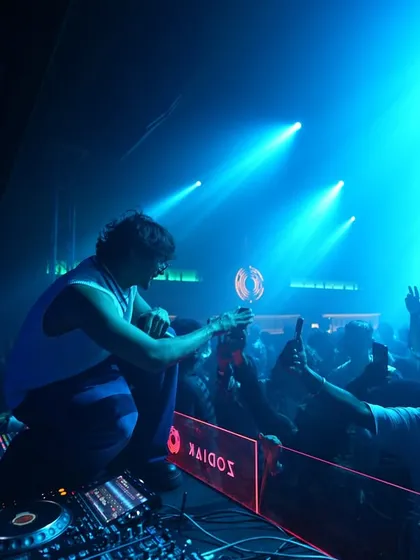Getting up close with the crowd at a packed club show. Crowd interaction is a huge part of my set; I'm on the mic, hyping everyone up and sharing the energy directly from the console.