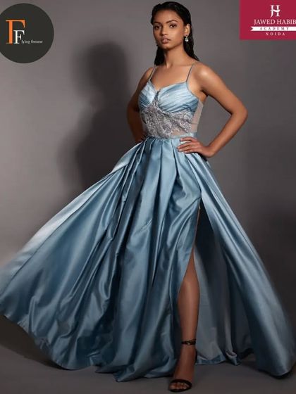 A model in a flowing blue satin gown, styled by our students during a high-fashion portfolio shoot.