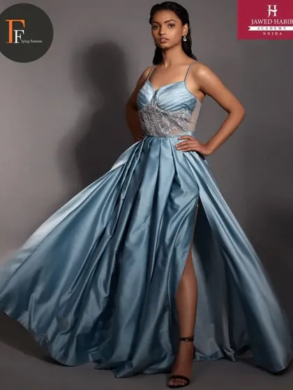 The model in the blue gown, captured in motion to showcase the flow of the dress and the elegance of the styling.