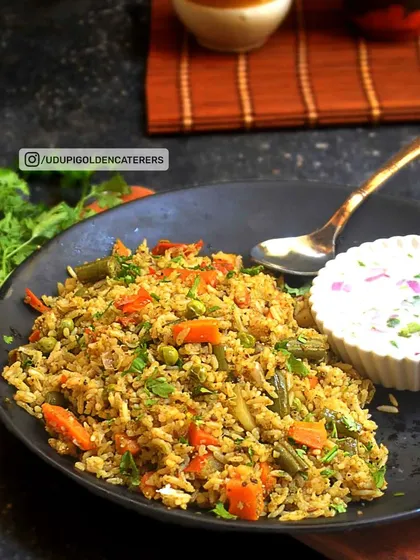 A look at our Vangibath, a traditional Karnataka rice dish made with a special spice blend, fresh vegetables, and garnished with coriander. This wholesome dish is a popular choice for breakfast and lunch catering.