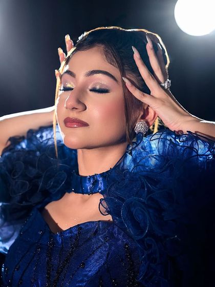 An artistic close-up with eyes closed, focusing on the metallic eyeshadow.