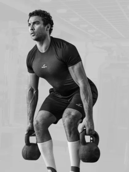 Lift heavy, train harder. A member performs a kettlebell deadlift, focusing on form to build a powerful posterior chain.