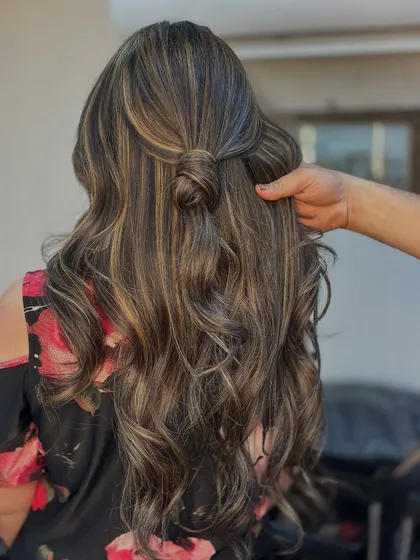 This half up knot style is perfect for showing off the intricate work of a balayage. The interwoven colors create a beautiful, textured look.