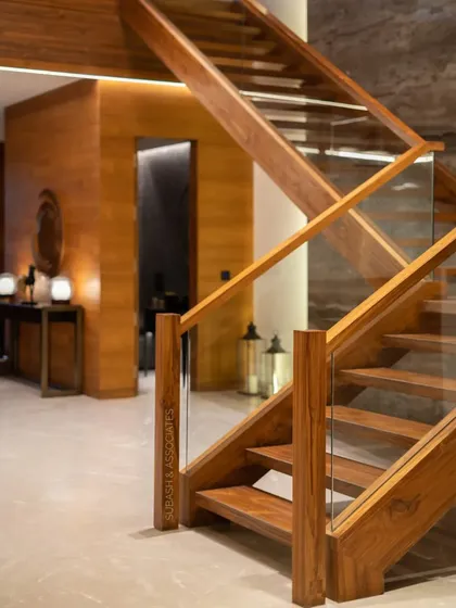 The simplest design is often the most effective. This wooden staircase with a glass railing is a testament to clean lines and quality craftsmanship.