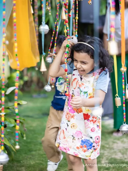 The purest moments are the most beautiful. Here, a child’s uninhibited joy is the centerpiece of our work. We create interactive spaces with details like these hanging bells, inviting little ones to play, explore, and make their own magic.